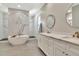This bathroom has marble floors, a tub, shower, and modern fixtures, complete with stylish double vanities at 2707 W Fig St, Tampa, FL 33609