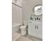 This bathroom features a modern vanity, a round mirror, and a bathtub with white subway tile at 2707 W Fig St, Tampa, FL 33609
