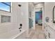 This bathroom features a bathtub with white subway tile, and a view into a nearby Bedroom at 2707 W Fig St, Tampa, FL 33609