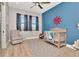 This nautical-themed bedroom is perfect for a , with a crib, rocking chair and matching decor at 2707 W Fig St, Tampa, FL 33609