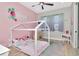 This pink bedroom for a is equipped with a bed, rug, decor, and a vanity and recessed lighting at 2707 W Fig St, Tampa, FL 33609