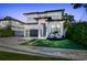 Beautiful two-story home with a modern design, black trim, and landscaped front yard at 2707 W Fig St, Tampa, FL 33609