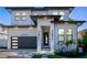 Beautiful two-story home with a modern design, black trim, and lush landscaping at 2707 W Fig St, Tampa, FL 33609