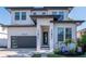 Modern two-story home with a black garage door and a landscaped front yard at 2707 W Fig St, Tampa, FL 33609
