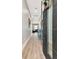Bright foyer with wood floors, a modern door, and a glimpse of the living area at 2707 W Fig St, Tampa, FL 33609