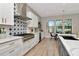 Open concept kitchen with stainless steel appliances, custom backsplash, and eat-in dining area at 2707 W Fig St, Tampa, FL 33609