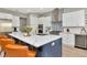 Modern kitchen with a spacious island, white countertops, stainless steel appliances, and a blue backsplash at 2707 W Fig St, Tampa, FL 33609