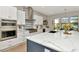 Island kitchen offers updated appliances and a gorgeous stone backsplash in a new construction home at 2707 W Fig St, Tampa, FL 33609