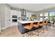 Island kitchen featuring stainless steel appliances, stylish seating, and ample counter space at 2707 W Fig St, Tampa, FL 33609