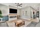 Cozy living room with a modern fireplace, light wood floors, and comfortable seating at 2707 W Fig St, Tampa, FL 33609