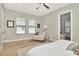 Relaxing primary bedroom featuring large windows, a cozy sitting area, and access to the ensuite bathroom at 2707 W Fig St, Tampa, FL 33609