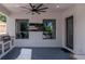 This covered outdoor kitchen boasts an integrated grill, bar, and a view to the outdoors at 2707 W Fig St, Tampa, FL 33609