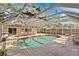 Refreshing screened pool with lounge chairs and dining area, perfect for outdoor relaxation and entertaining at 271 Kayli Ln, Palm Harbor, FL 34683
