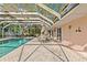 A screened-in pool with outdoor seating, perfect for relaxation and entertaining at 271 Kayli Ln, Palm Harbor, FL 34683