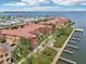 Waterfront property features terracotta roofs, private docks and manicured lawns at 2757 Via Cipriani # 1121B, Clearwater, FL 33764