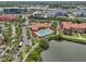 Aerial view of the community pool, lake, and surrounding residential area at 2757 Via Cipriani # 1121B, Clearwater, FL 33764