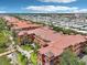 Aerial shot highlights terracotta-roofed buildings, lush landscaping, and waterfront location at 2757 Via Cipriani # 1121B, Clearwater, FL 33764
