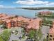Stunning aerial view of the property with terracotta roofs, lush landscaping and waterfront views at 2757 Via Cipriani # 1121B, Clearwater, FL 33764