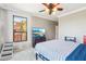Comfortable bedroom featuring carpet floors, ample natural light, and a built-in TV at 2757 Via Cipriani # 1121B, Clearwater, FL 33764