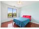 Comfortable bedroom featuring hardwood floors, ample natural light, and a ceiling fan at 2757 Via Cipriani # 1121B, Clearwater, FL 33764