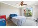 Comfortable bedroom with ample natural light, carpet floors, and views of a lush green garden at 2757 Via Cipriani # 1121B, Clearwater, FL 33764