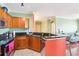 Cozy kitchen featuring wood cabinets, dark granite countertops, and stainless steel appliances at 2757 Via Cipriani # 1121B, Clearwater, FL 33764