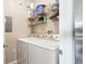 Functional laundry area with a white washer and dryer, and practical shelving for storage at 2757 Via Cipriani # 1121B, Clearwater, FL 33764