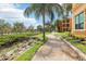 Brick path winds through landscaped grounds near the waterway and building at 2757 Via Cipriani # 1121B, Clearwater, FL 33764