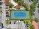 Aerial view of community tennis court with gazebo and parking in a well maintained residential area at 2757 Via Cipriani # 1121B, Clearwater, FL 33764
