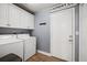 Laundry room with washer, dryer, storage cabinets and Laundry Co. sign at 3212 Alcott Ave, Plant City, FL 33566