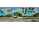Exterior of the blue and white Wave condominium building showing parking and mature palms at 3315 58Th S Ave # 509, St Petersburg, FL 33711