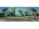 Exterior of the blue and white Wave condominium building showcasing ample parking at 3315 58Th S Ave # 509, St Petersburg, FL 33711