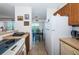 Bright kitchen featuring full sized refrigerator, dining area and balcony access at 3315 58Th S Ave # 509, St Petersburg, FL 33711