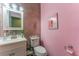 Charming bathroom with pink walls, a decorative mirror, and modern fixtures at 337 S Plant Ave, Tampa, FL 33606