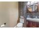 Stylish half bathroom with mosaic tile, a wooden-framed mirror, and a modern sink at 337 S Plant Ave, Tampa, FL 33606