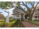 Charming two-story building with brick walkway, lush greenery, and mature trees offering a welcoming entrance at 337 S Plant Ave, Tampa, FL 33606