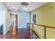 Second story hallway with wood floors, modern railings, and bright natural light at 337 S Plant Ave, Tampa, FL 33606