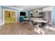 Open-concept kitchen with stainless steel appliances, white cabinets, and a dining area at 337 S Plant Ave, Tampa, FL 33606