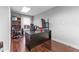 Spacious office featuring hardwood floors, a modern desk setup with multiple monitors and a bookshelf at 337 S Plant Ave, Tampa, FL 33606