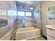 Bathroom featuring tiled shower and wall, window and white tub at 3911 6Th W Ave, Palmetto, FL 34221