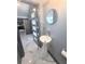 Stylish bathroom featuring a pedestal sink, modern fixtures, and a unique door, enhancing the home's contemporary appeal at 3911 6Th W Ave, Palmetto, FL 34221