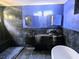 Modern bathroom featuring dual vanities, sleek lighting, and a soaking tub at 3911 6Th W Ave, Palmetto, FL 34221