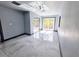 A bright bedroom featuring tiled floors, modern ceiling fan and sliding glass doors at 3911 6Th W Ave, Palmetto, FL 34221
