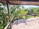 Expansive wooden deck overlooking a lush backyard with mature trees at 3911 6Th W Ave, Palmetto, FL 34221