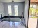 Bright foyer with pendant lighting, railing, and views of the outdoor deck at 3911 6Th W Ave, Palmetto, FL 34221