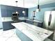 Kitchen featuring modern stainless steel appliances, white marble countertops and a blue-grey accent wall at 3911 6Th W Ave, Palmetto, FL 34221