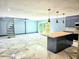 Open-concept living and kitchen area featuring marble floors, spiral stairs, and modern, stainless steel appliances at 3911 6Th W Ave, Palmetto, FL 34221