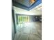Spacious living room featuring geometric tile floor and sliding glass door to the yard at 3911 6Th W Ave, Palmetto, FL 34221