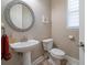 Bathroom with a mosaic mirror, window with blinds, pedestal sink, and toilet, nice decor at 4014 W Swann Ave, Tampa, FL 33609