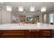 Modern kitchen island featuring a marble countertop, wood cabinets, and elegant pendant lighting at 4014 W Swann Ave, Tampa, FL 33609